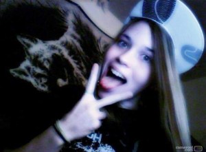 Axton , white and black flat bill, peace sign , tongue out 