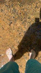 Feet in the water at triple falls.
