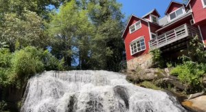 Old mill now is a rehab, pained red. Huge water fall.