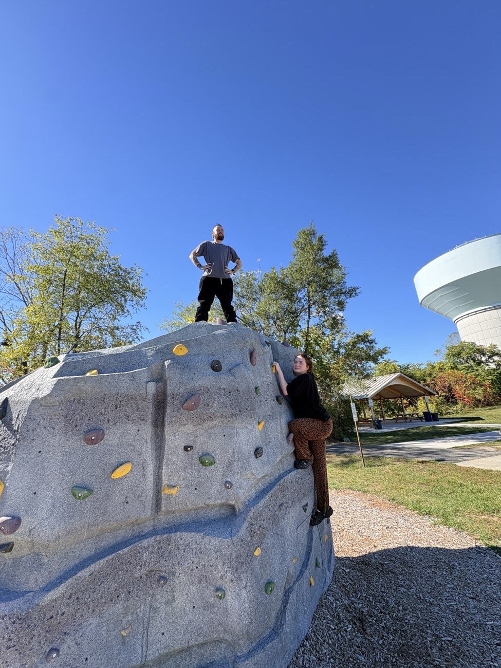 Axton stand's on top of climbable rock wall while his friend is stuck on the side