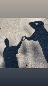 Axton and kelso making shadow trail hearts on a walk they shared for their 4 year anniversary 