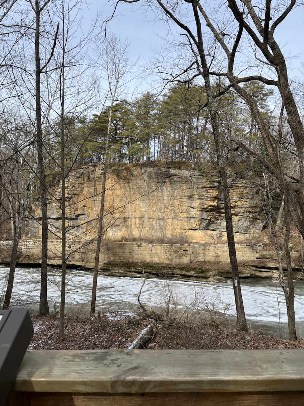 Black hand sandstone cliffs and a frozen river