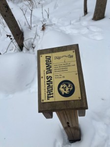 Sign for Bo surrounded by snow
