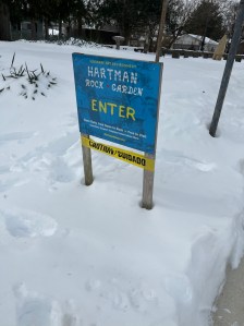 Hartman rock garden sign surrounded by snow