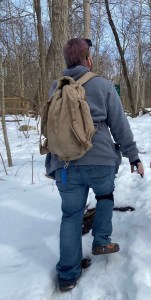 Axton walking the troll trail at Aullwood Audubon wearing jeans bookbag and faded purple hair