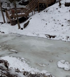 Frozen big Wheeling creek with new wooden stairs to creek bank