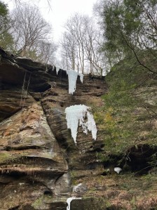 Semi Frozen waterfalll on sandstone cliffs